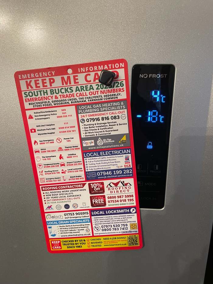 Keep Me Card pinned to a kitchen fridge — South Bucks emergency trades card 2025/26 showing local plumber and electrician contacts